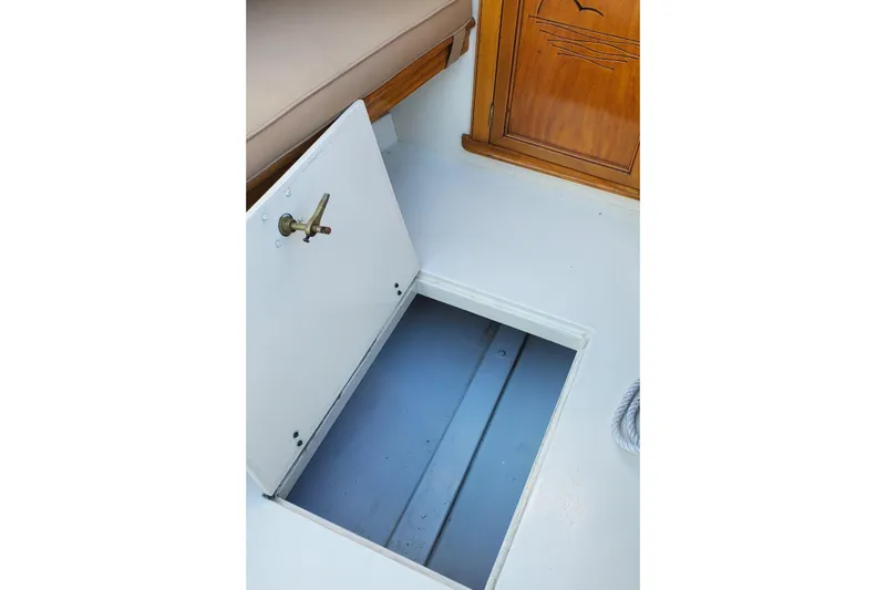 Slide: The Image of Open hatch on 2016 First Light Monomoy 26 boat, revealing storage compartment. - 12