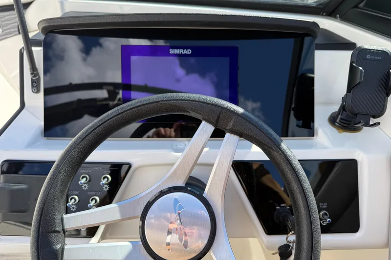 Slide: The Image of Steering wheel and dashboard of 2023 Sea Ray SPX 230 Outboard boat. - 10