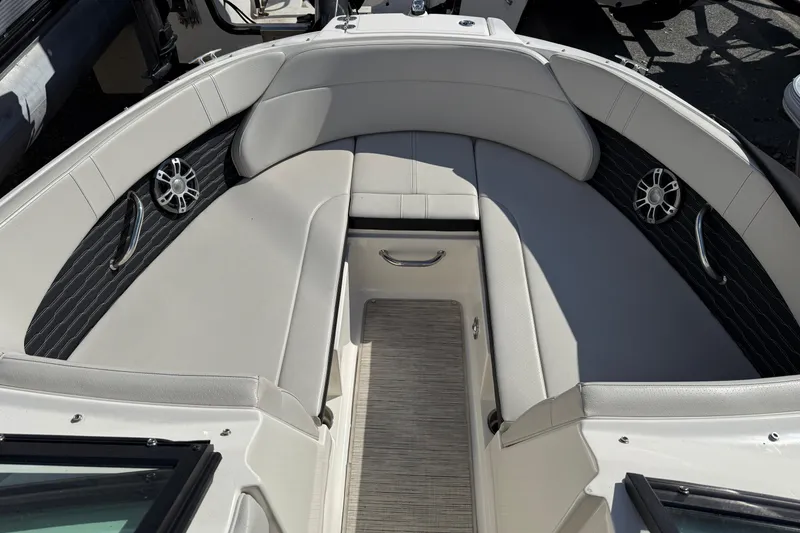 Slide: The Image of 2023 Sea Ray SPX 230 Outboard boat interior with cushioned seating and speakers. - 5