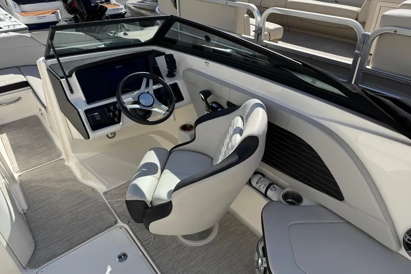 Slide: The Image of 2023 Sea Ray SPX 230 Outboard boat interior with steering wheel and seating. - 6