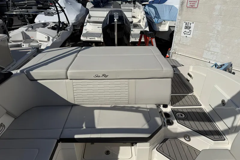 Slide: The Image of 2023 Sea Ray SPX 230 Outboard boat interior with cushioned seating and sleek design. - 8