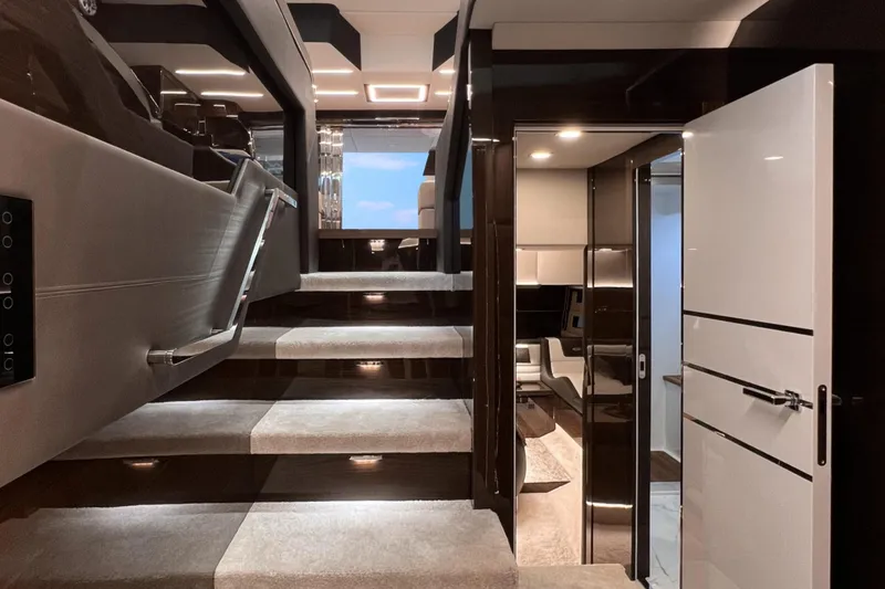 Slide: The Image of Luxurious interior of 2026 Cobrey 52 FLY yacht with modern staircase and sleek design. - 14