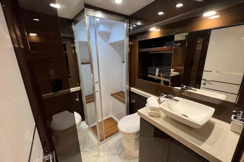 Slide: The Image of Luxurious bathroom in 2026 Cobrey 52 FLY yacht with modern fixtures and elegant design. - 16