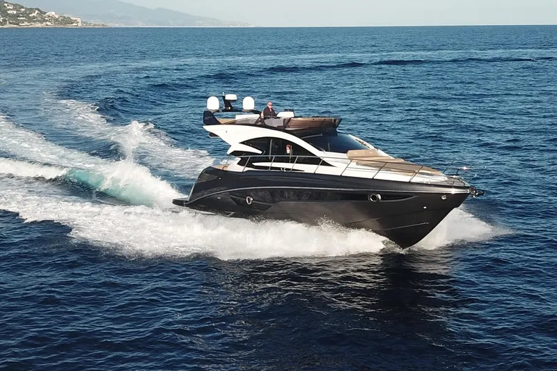 Slide: The Image of Luxurious 2026 Cobrey 52 FLY yacht cruising on open sea. - 4