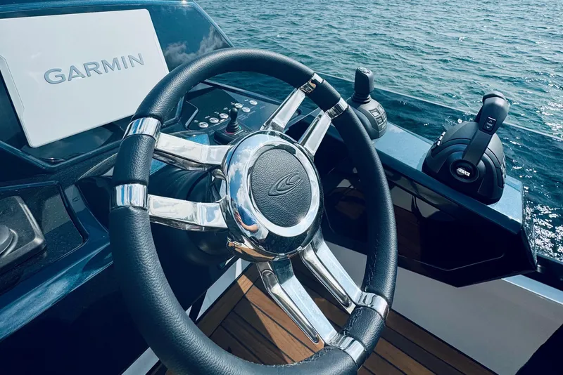 Slide: The Image of Steering wheel of 2026 Cobrey 52 FLY yacht with Garmin navigation system. - 8