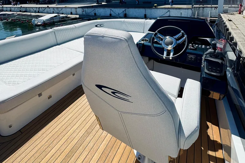 Slide: The Image of Luxurious 2026 Cobrey 52 FLY yacht cockpit with elegant seating and modern steering console. - 9