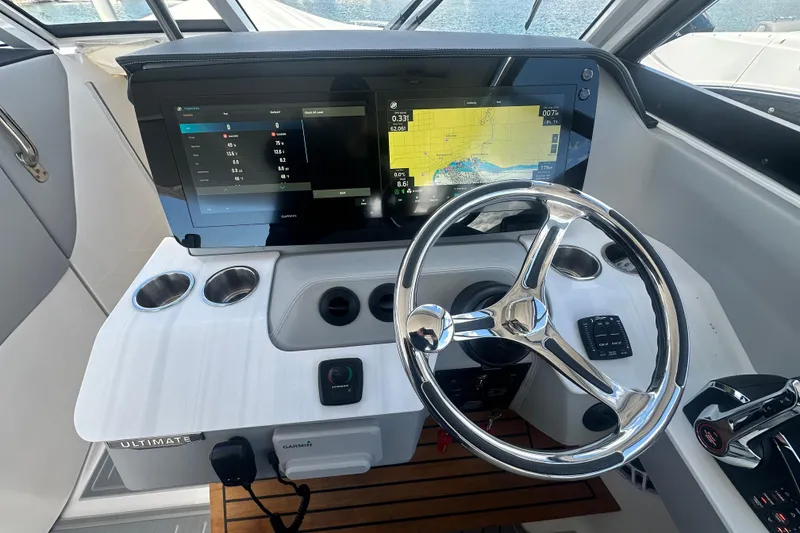 Slide: The Image of Helm of 2025 Regal LX36 boat with advanced navigation displays and controls. - 11