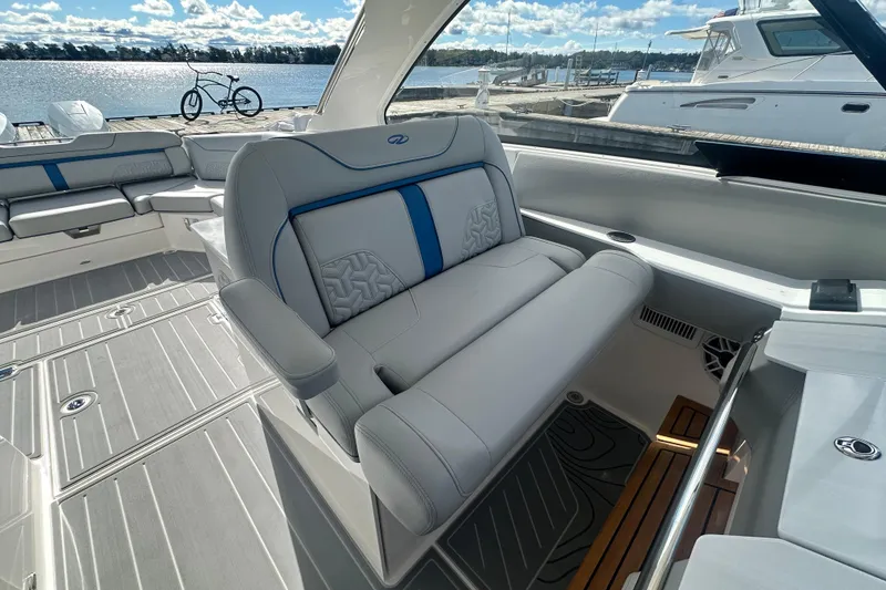 Slide: The Image of Luxurious interior of 2025 Regal LX36 boat with plush seating and scenic waterfront view. - 13
