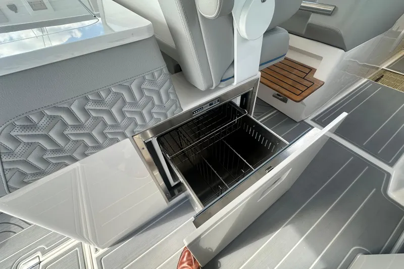 Slide: The Image of Open storage compartment on 2025 Regal LX36 boat, featuring sleek interior design and modern amenities. - 14