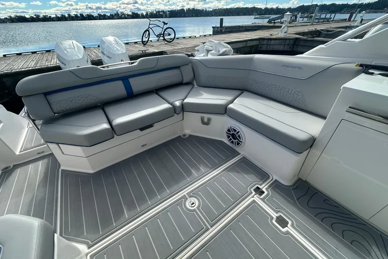Slide: The Image of Luxurious seating area on a 2025 Regal LX36 boat, docked by the water. - 17
