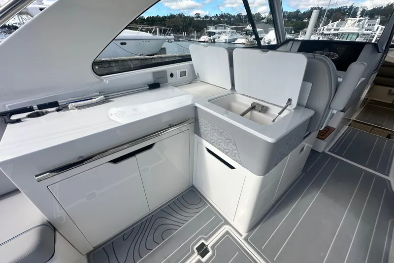 Slide: The Image of Modern interior of 2025 Regal LX36 yacht with sleek kitchenette and marina view. - 18