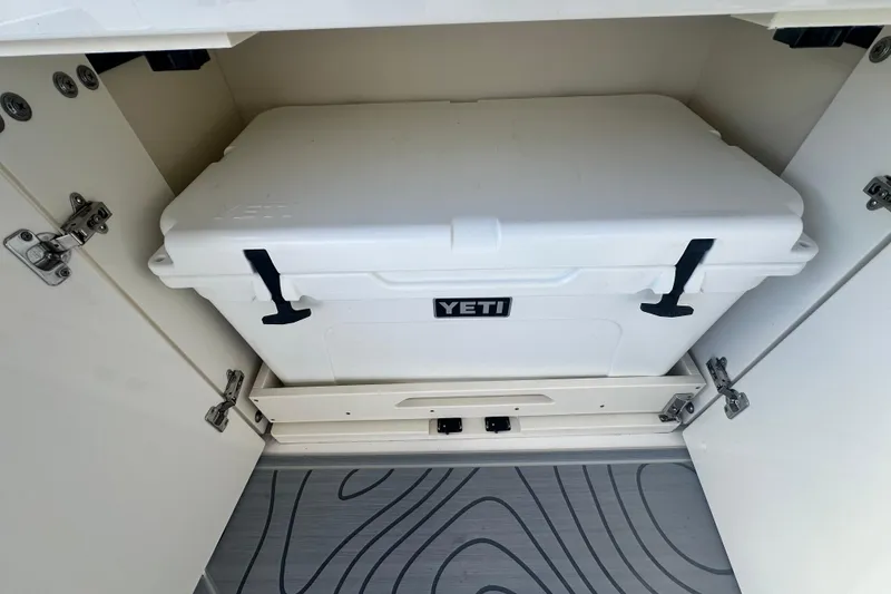 Slide: The Image of White YETI cooler stored in 2025 Regal LX36 compartment. - 20