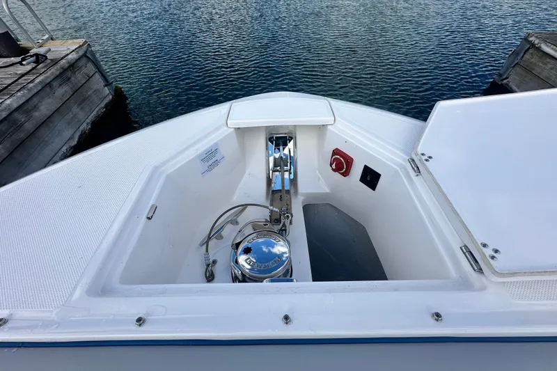 Slide: The Image of Bow view of 2025 Regal LX36 boat with anchor compartment open. - 26