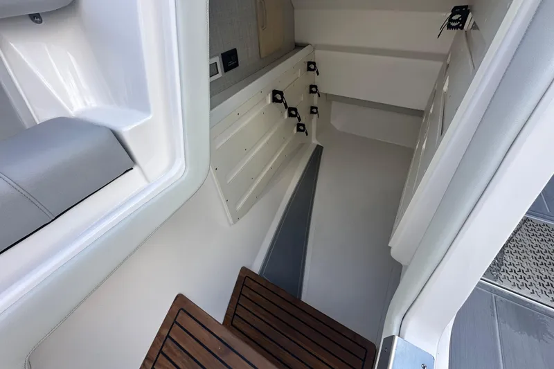 Slide: The Image of Interior view of 2025 Regal LX36 boat, featuring sleek design and wooden steps. - 27