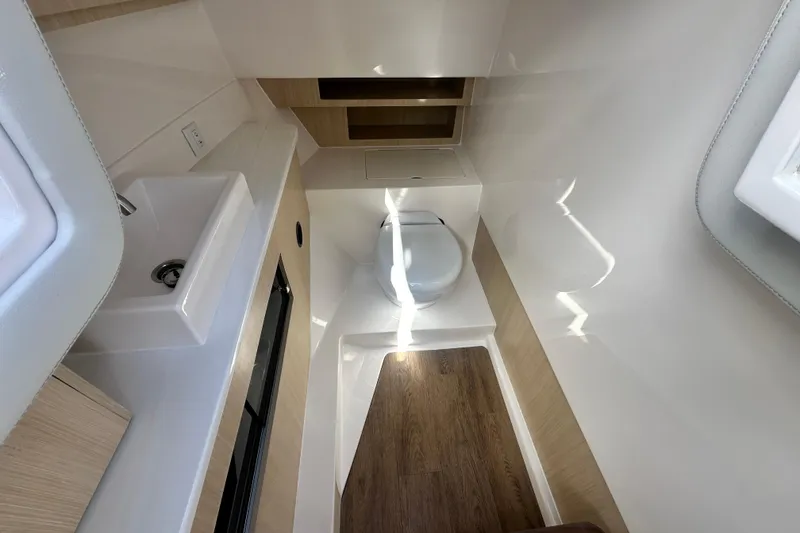 Slide: The Image of 2025 Regal LX36 boat interior bathroom with modern sink and toilet design. - 28