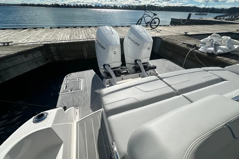 Slide: The Image of 2025 Regal LX36 boat with dual Mercury engines docked by the water. - 30