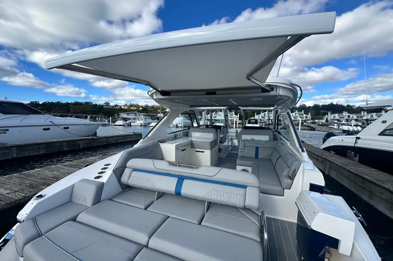 Slide: The Image of 2025 Regal LX36 luxury boat with spacious seating at marina dock. - 36