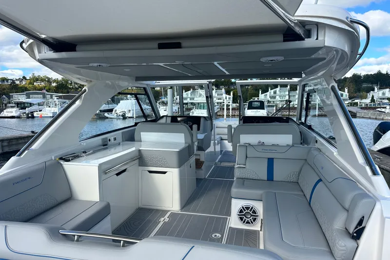 Slide: The Image of 2025 Regal LX36 luxury boat interior with modern seating and sleek design at marina. - 37