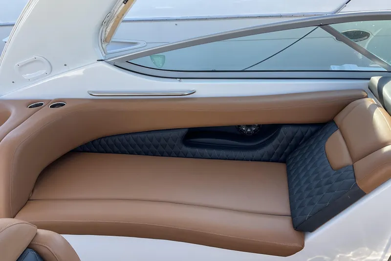 Slide: The Image of 2019 Rinker 290 Express Cruiser interior with tan and black seating. - 5