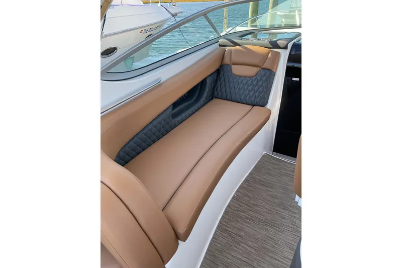 Slide: The Image of 2019 Rinker 290 Express Cruiser interior seating with tan and gray upholstery. - 8