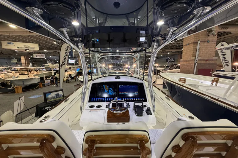 Slide: The Image of 2026 Valhalla Boatworks V-33 helm at a boat show, featuring advanced navigation technology. - 11