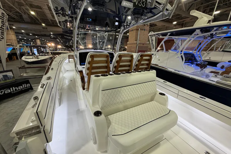 Slide: The Image of 2026 Valhalla Boatworks V-33 interior at a boat show, showcasing luxury seating and design. - 13