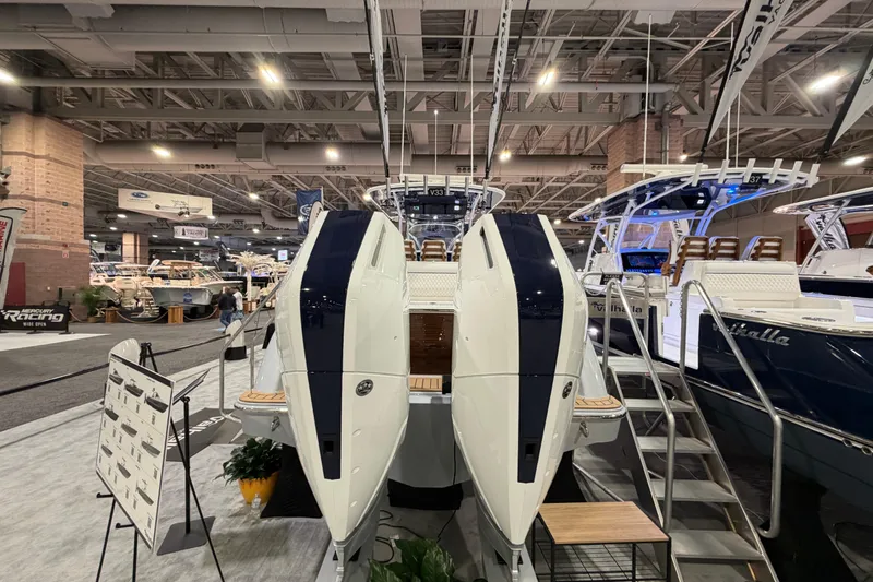 Slide: The Image of 2026 Valhalla Boatworks V-33 displayed at a boat show, showcasing sleek design and powerful engines. - 16