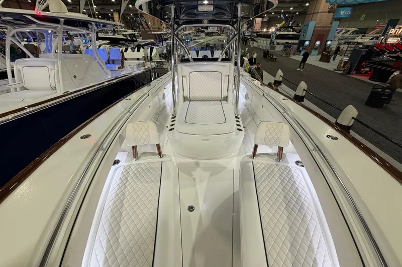 Slide: The Image of 2026 Valhalla Boatworks V-33 interior with luxurious seating and modern design at a boat show. - 3