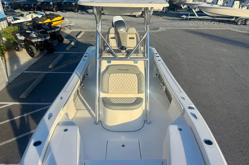 Slide: The Image of 2026 Avenger AV26 boat with cushioned seating and T-top in a parking lot. - 17