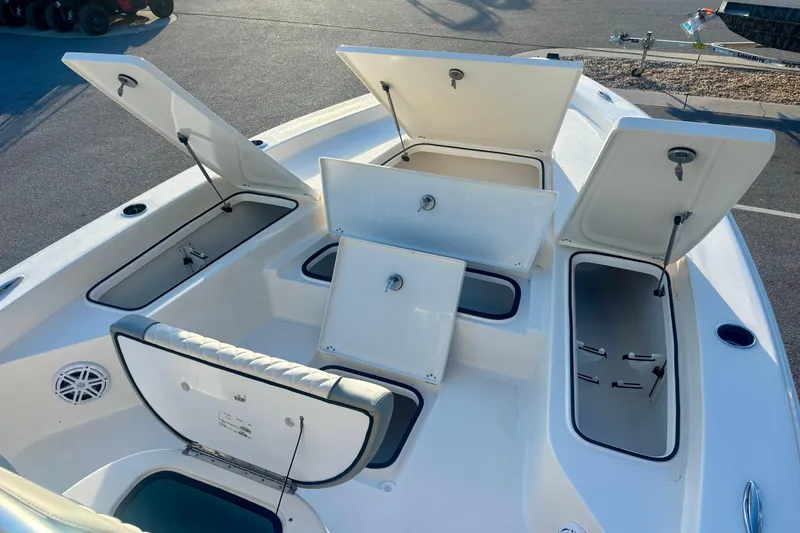 Slide: The Image of Open storage compartments on 2026 Avenger AV26 boat deck in sunlight. - 19