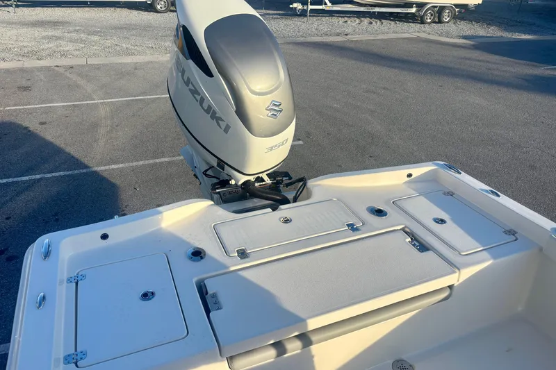 Slide: The Image of 2026 Avenger AV26 boat with Suzuki outboard motor in a parking lot. - 20