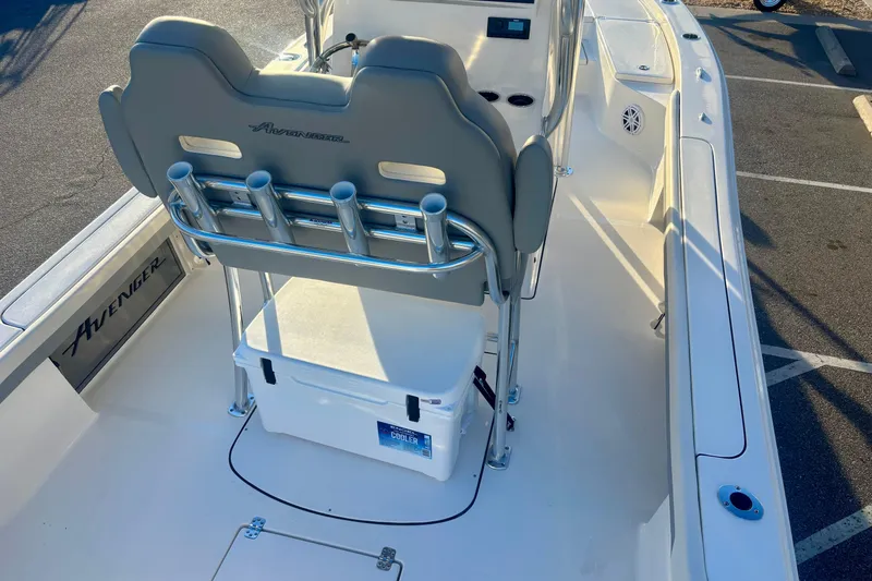 Slide: The Image of 2026 Avenger AV26 boat interior with seating, rod holders, and cooler on deck. - 21