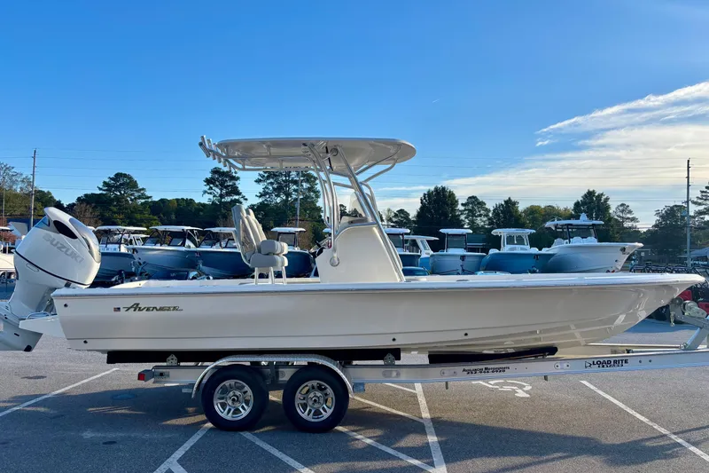 Slide: The Image of 2026 Avenger AV26 boat on trailer, parked in a lot under clear blue sky. - 3