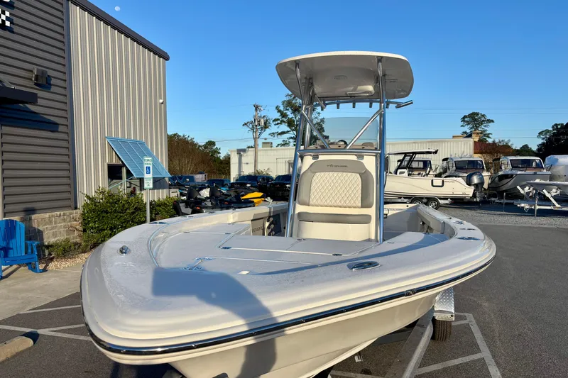 Slide: The Image of 2026 Avenger AV26 boat displayed outdoors at a dealership under clear blue sky. - 9