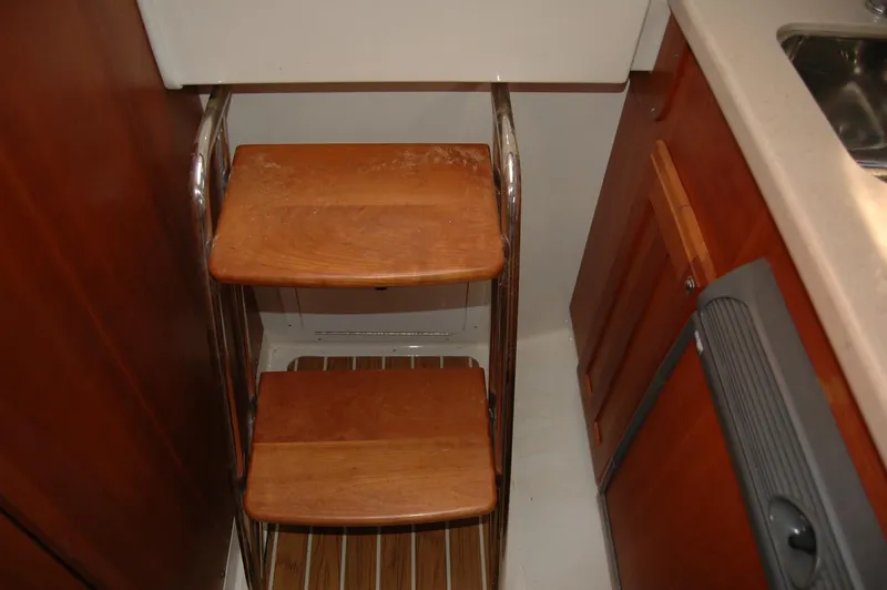 Slide: The Image of Wooden steps in a 2006 Back Cove 26 boat interior, featuring metal railings. - 20