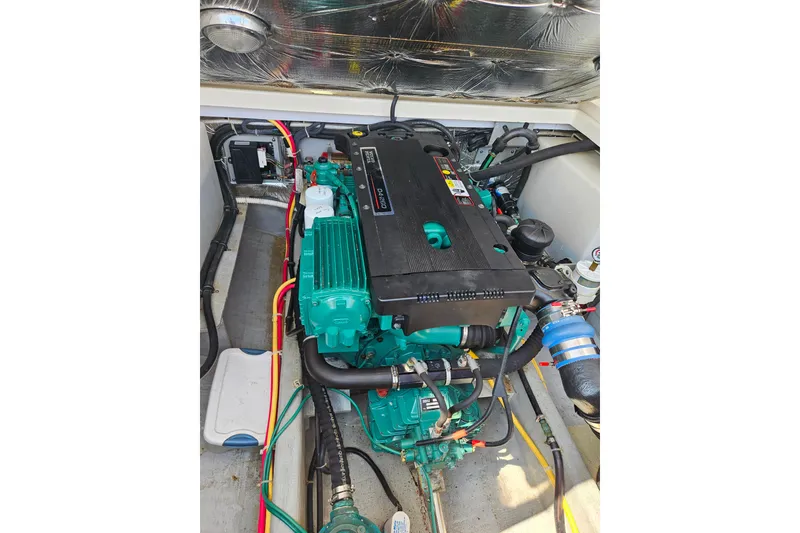 Slide: The Image of Engine compartment of a 2006 Back Cove 26 boat, showcasing detailed components. - 24