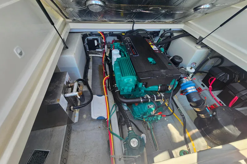 Slide: The Image of Engine compartment of a 2006 Back Cove 26 boat, showcasing detailed mechanical components. - 26
