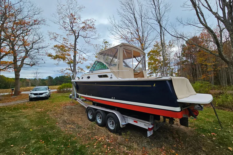 Slide: The Image of 2006 Back Cove 26 boat on trailer, surrounded by autumn trees and parked car. - 29