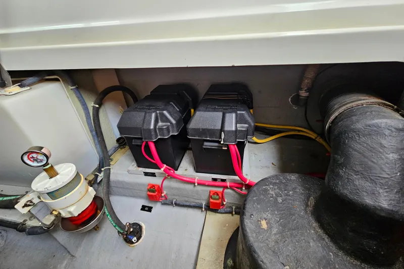 Slide: The Image of Engine compartment of a 2006 Back Cove 26 boat with batteries and wiring. - 33