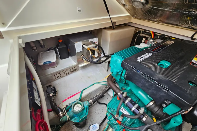 Slide: The Image of Engine compartment of a 2006 Back Cove 26 boat, featuring a well-maintained marine engine. - 35