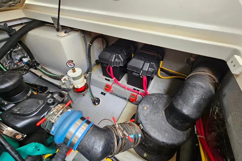 Slide: The Image of Engine compartment of a 2006 Back Cove 26 boat, showing batteries and wiring. - 36