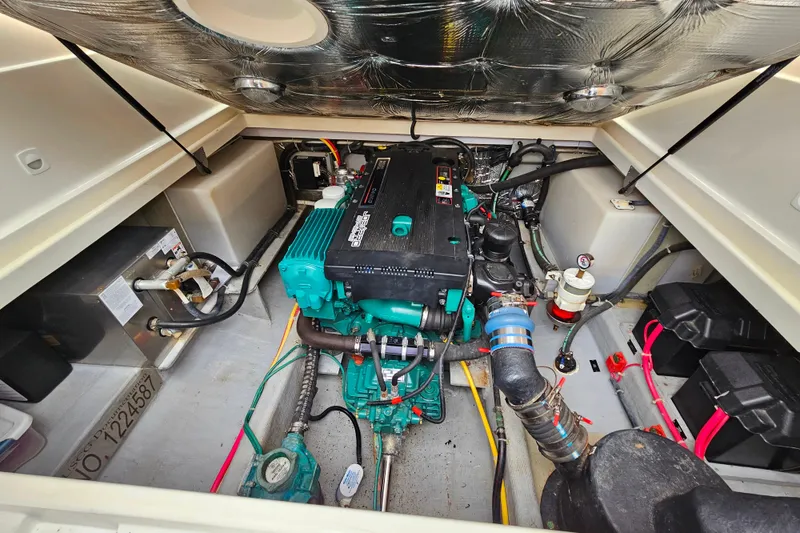 Slide: The Image of Engine compartment of a 2006 Back Cove 26 boat, showcasing detailed mechanical components. - 37