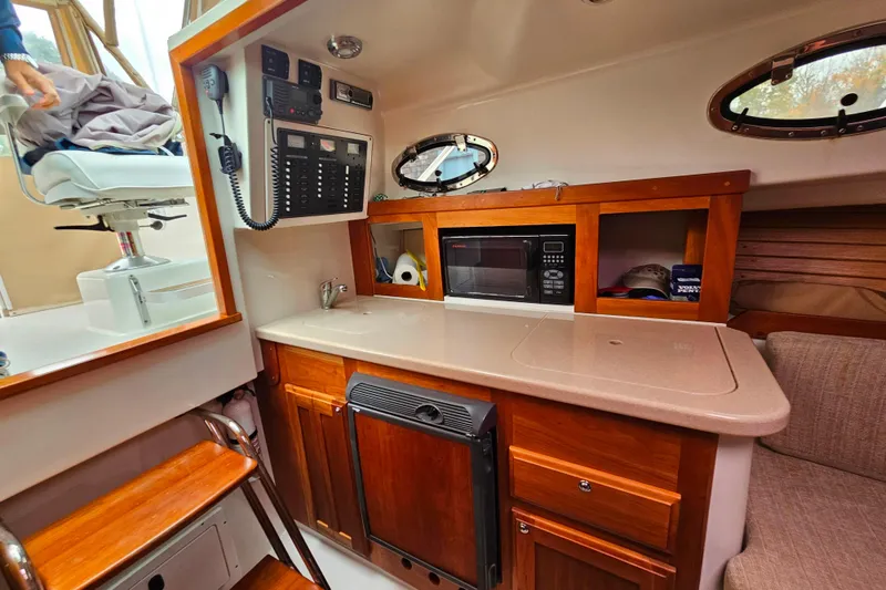 Slide: The Image of 2006 Back Cove 26 interior with kitchenette, microwave, and control panel. - 38