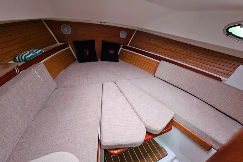 Slide: The Image of Cozy cabin interior of 2006 Back Cove 26 boat with cushions and wooden accents. - 42