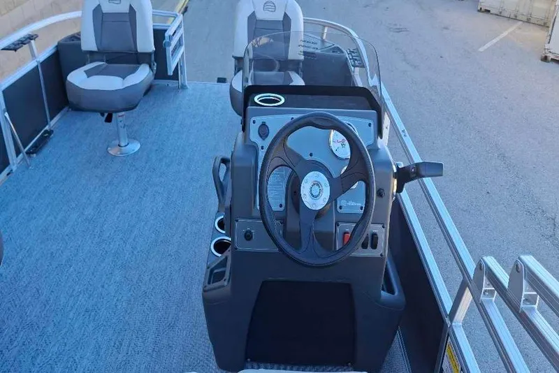 Slide: The Image of 2026 Sun Tracker Bass Buggy 18 DLX pontoon boat interior with steering console. - 37
