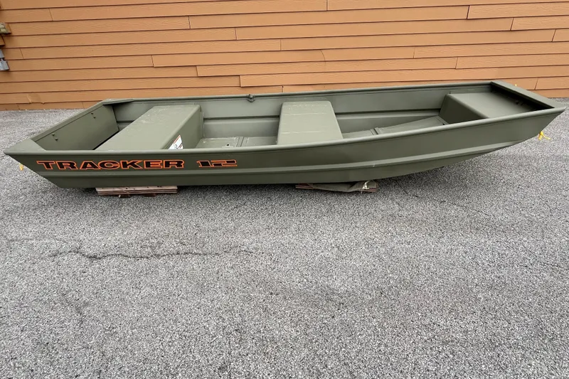 The Image of 2026 Tracker Grizzly 12 Jon boat, olive green, displayed outdoors on pavement. - 0