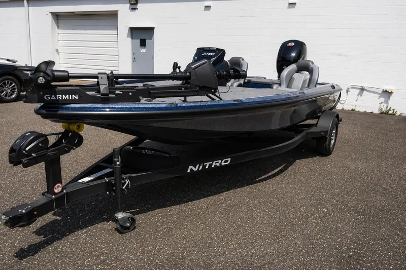 Slide: The Image of 2026 Nitro Z18 Pro fishing boat with Garmin equipment on a trailer, parked outdoors. - 1