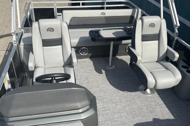 Slide: The Image of 2026 Sun Tracker Party Barge 22 RF DLX interior with gray seating and table. - 14