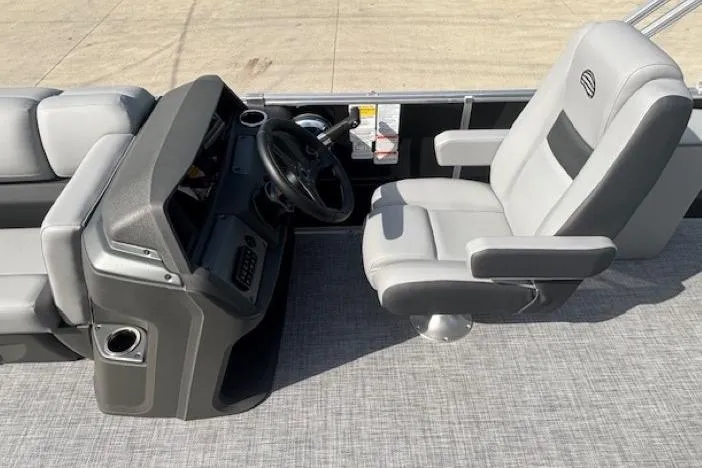 Slide: The Image of 2026 Sun Tracker Party Barge 22 RF DLX helm with gray captain's chair and console. - 16