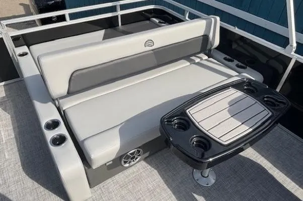 Slide: The Image of 2026 Sun Tracker Party Barge 22 RF DLX with seating and table, featuring cup holders. - 19